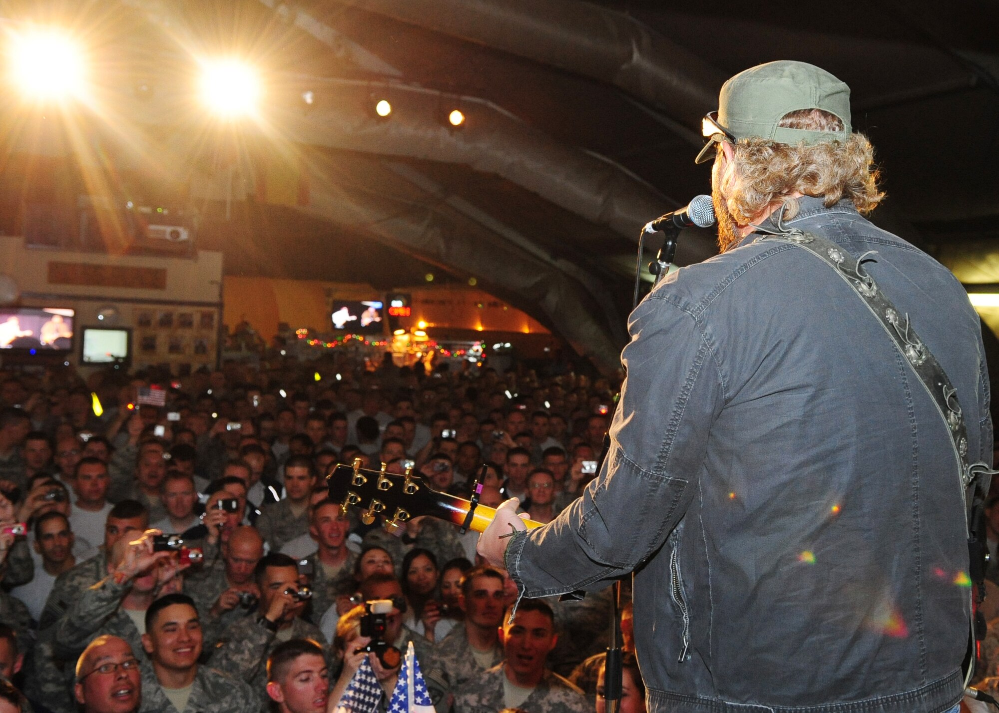 Toby Keith entertains Airmen, Soldiers, Sailors, Marines, DoD employees, contract civilians, and coalition forces during a free USO concert at Pete's Place May 7, 2010. (U.S. Air Force photo/ Senior Airman Nichelle Anderson) 
