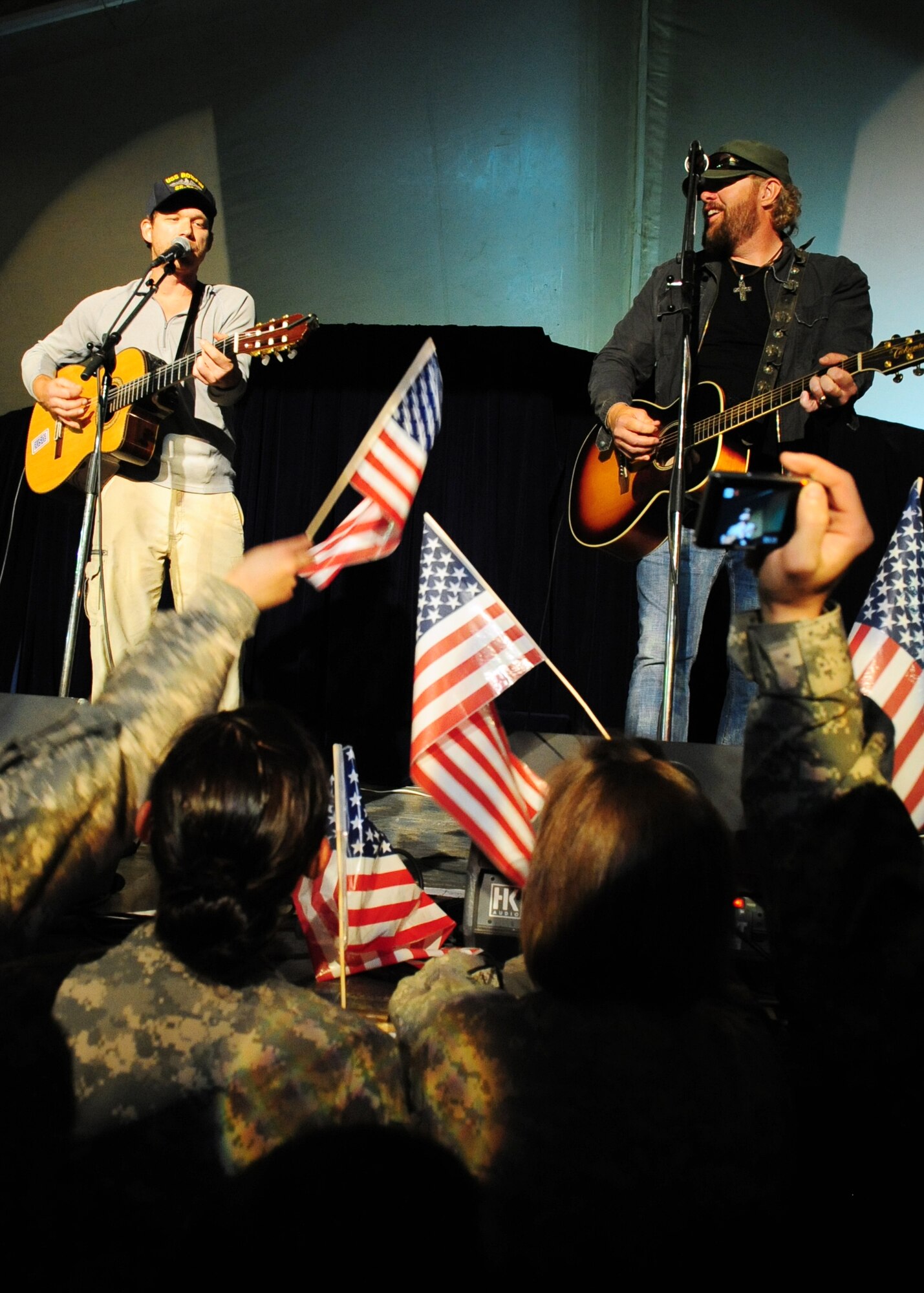 Toby Keith and Walter "Scotty" Emerick entertain Airmen, Soldiers, Sailors, Marines, DoD employees, contract civilians, and coalition forces during a free USO concert at Pete's Place May 7, 2010. (U.S. Air Force photo/ Senior Airman Nichelle Anderson)