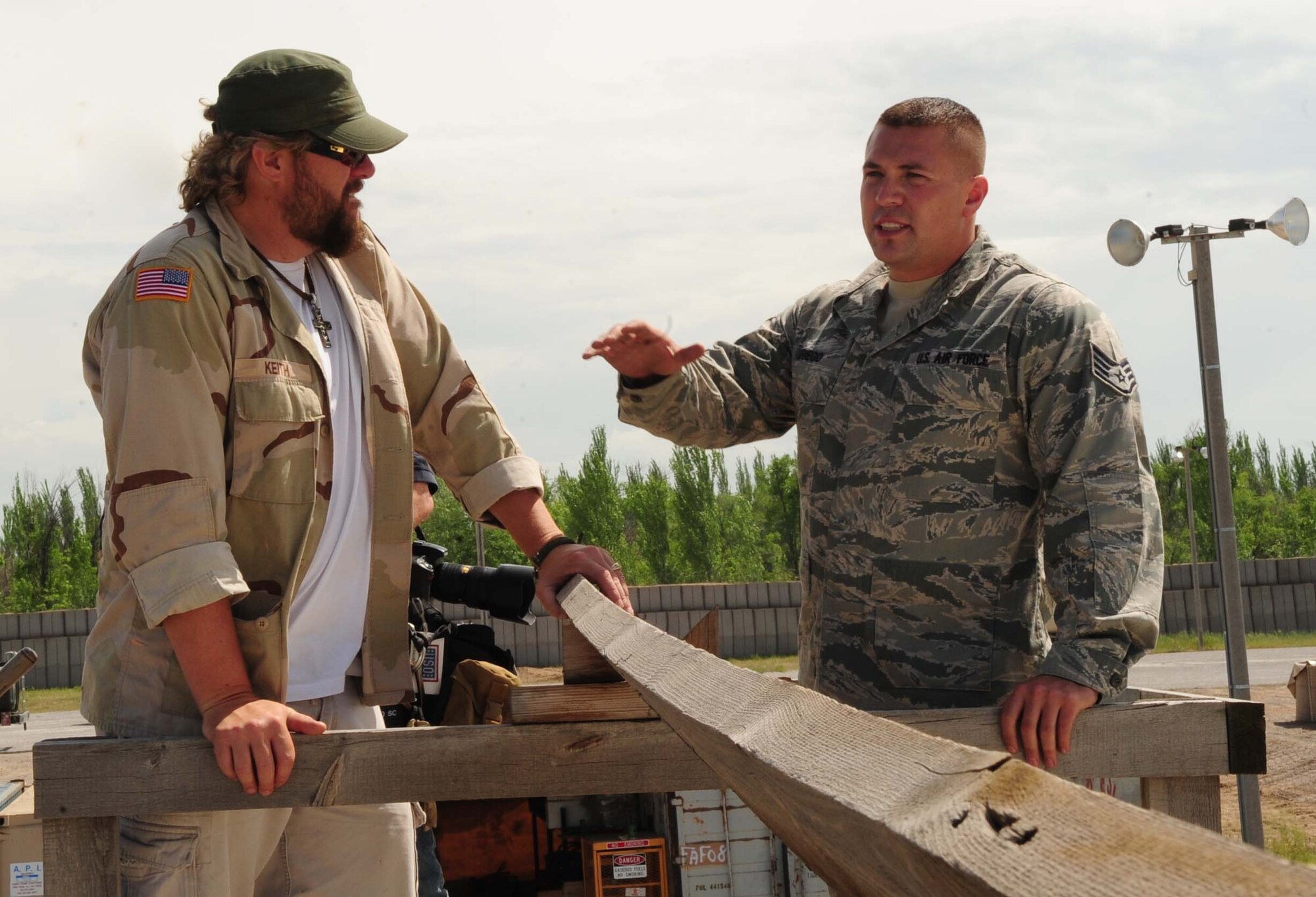 Staff Sgt. Dominick Griego, a 376th Expeditionary Logistics Readiness Squadron petroleum, oil and lubricants specialist, shows Toby Keith the fuel compound during a USO tour to the Transit Center at Manas, Kyrgyzstan, May 7, 2010. (U.S. Air Force photo/Staff Sgt. Carolyn Viss)