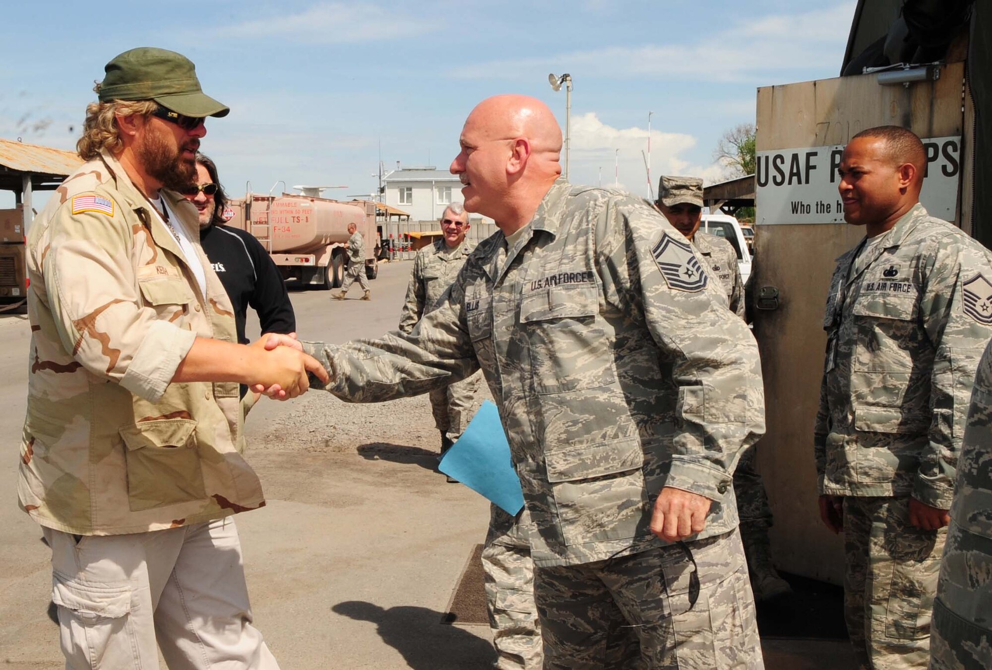 Senior Master Sgt. Henry Ellis, the 376th Expeditionary Logistics Readiness Squadron petroleum, oil and lubricants superintendent, greets Toby Keith during a USO tour to the Transit Center at Manas, Kyrgyzstan, May 7, 2010. (U.S. Air Force photo/Staff Sgt. Carolyn Viss)