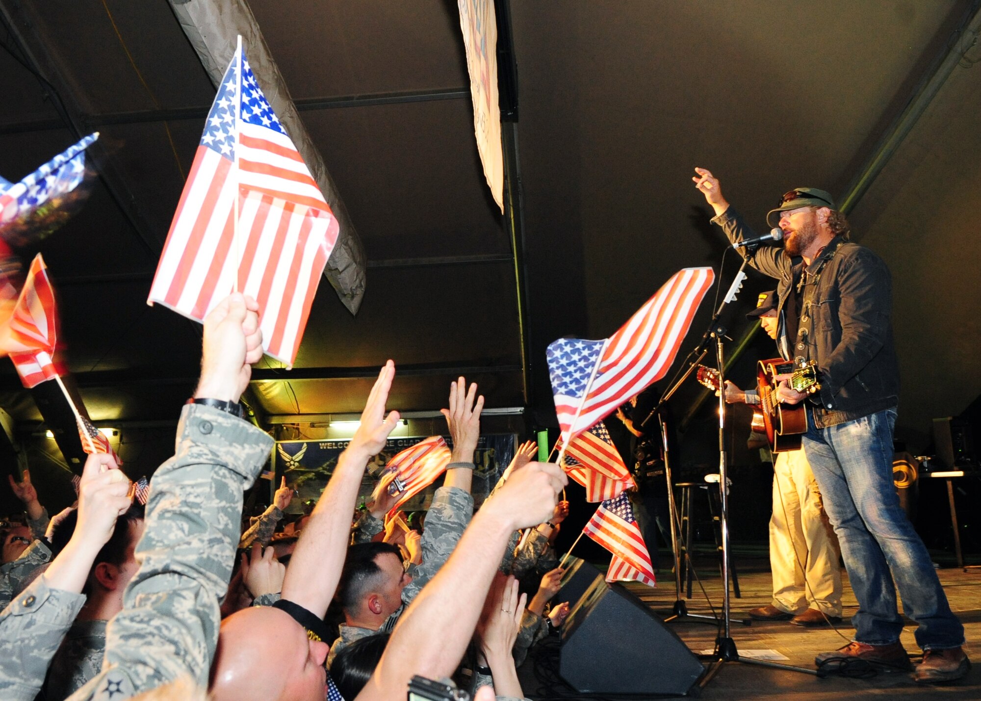 Toby Keith entertains Airmen, Soldiers, Sailors, Marines, DoD employees, contract civilians, and coalition forces during a free USO concert at the Transit Center at Manas, Kyrgyzstan, May 7, 2010. More than 1,000 service members attended the show where Toby Keith performed some of his chart-topping hits. (U.S. Air Force photo/ Senior Airman Nichelle Anderson) 