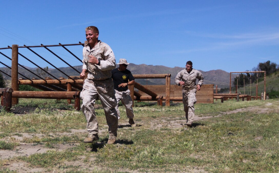 Sgt. Kirby G. Fanus (left), and Cpl. Anton Hoffman, both reserve Marines and reconnaissance men with 4th Recon Battalion, 4th Marine Division, run through Camp Horno’s obstacle course, during Camp Pendleton’s 2nd Annual Recon Challenge, May 8. This was one of several events during the challenge that covered 24 miles of hiking, a 2 kilometer back-pack swim, a live fire drill and a rappelling exercise, which is exclusive to Recon Marines.