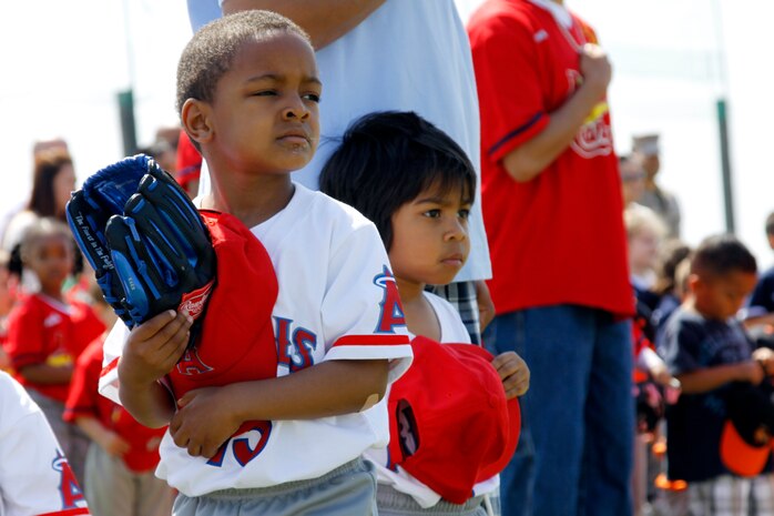 An Angels baseball player participating in the 3 - 4 year old division holds his hat over his heart while listening to the national anthem during the opening ceremony at Penny Lake field here, which officially started this year’s youth baseball season May 8. Approximately 286 youth, ages 3-15, are signed up to participate in this year’s youth baseball season.
