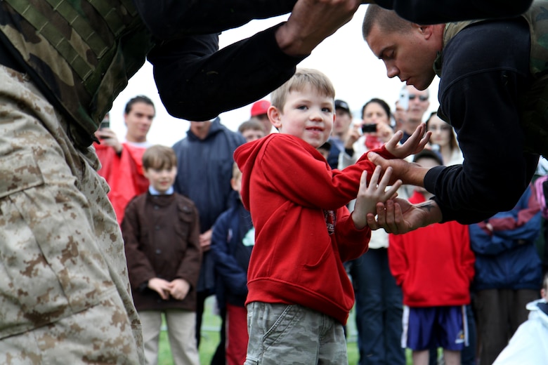 Sgt. Steven N. Richardson shows a young spectator techniques from the Marine Corps Martial Arts Program at the Marine Week Boston family day May 8, 2010. Marine Week gives Boston residents a chance to experience the Corps' history, culture and traditions.