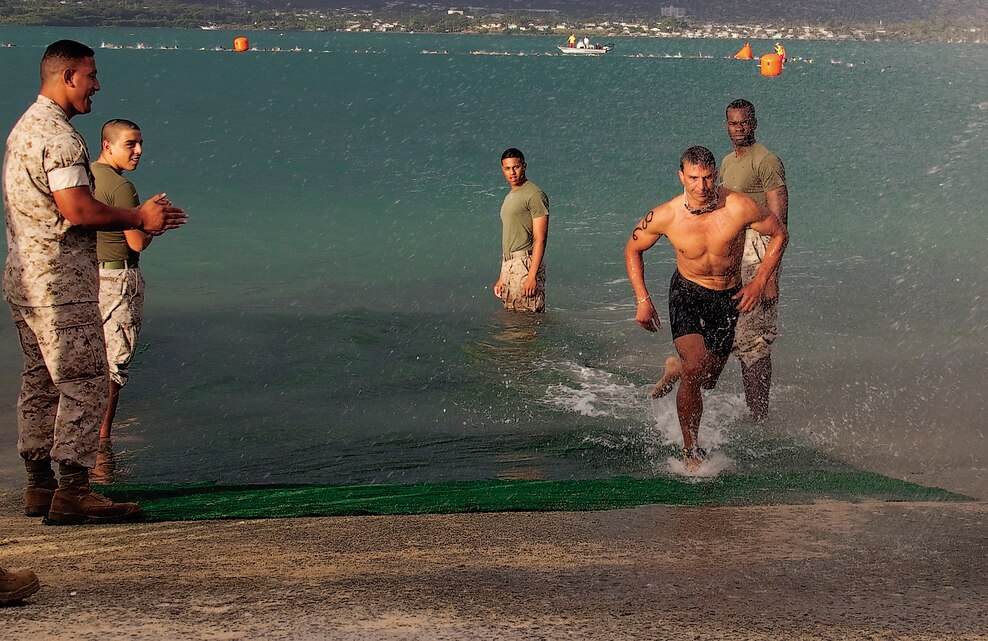 John Akana, the overall winner of the Commanding Officer’s Fitness Series’ Sprint Triathlon rushes out of Kaneohe Bay after his 500-meter portion, Lance Cpl. Ronald W. Stauffer.