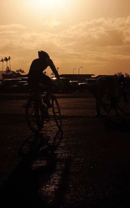 A cyclist participating in the Commanding Officer’s Fitness Series’ Sprint Triathlon May 8, pedals through an 11.1-mile journey around the base.