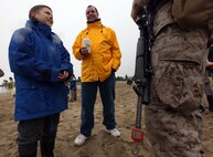 Gus O'Brien and his 9-year-old son, Alexander, speak to a Marine serving with 3rd Battalion, 24th Marine Regiment, just after Marines stormed Carson Beach as part of a demonstration May 8, 2010.