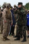 Lance Cpl. Michael Winters, a mortarman with 3rd Battalion, 24th Marines, shows his M-16 A4 service rifle to Kyle Wagner, a 14 year old Private First Class with the Fore River Young Marines Program, at Joe Moakley Park, Boston during a static display set up for Marine Week Boston, May 8, 2010. Marine Week provides an opportunity to increase public awareness of the Marine Corps' value to our nation's defense and to preserve and mature the Corps' relationship with the American people.
