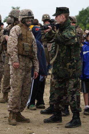 Lance Cpl. Michael Winters, a mortarman with 3rd Battalion, 24th Marines, shows his M-16 A4 service rifle to Kyle Wagner, a 14 year old Private First Class with the Fore River Young Marines Program, at Joe Moakley Park, Boston during a static display set up for Marine Week Boston, May 8, 2010. Marine Week provides an opportunity to increase public awareness of the Marine Corps' value to our nation's defense and to preserve and mature the Corps' relationship with the American people.