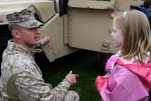 Cpl. Robert Mabry of 3rd Battalion, 24th Marines, India Company, out of Nashville, Tenn., explains the uses of a M1151 high mobility, multi-purpose, wheeled vehicle to a young girl at Joe Moakley Park, Boston during a static display set up for Marine Week Boston, May 8, 2010. Marine Week provides an opportunity to increase public awareness of the Marine Corps' value to our nation's defense and to preserve and mature the Corps' relationship with the American people.
