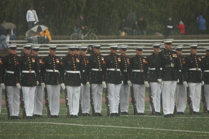 The Silent Drill Platoon, Marine Barracks Washington, stands at attention during a hailstorm at Moakley Field in Boston, May 8, 2010. The sudden storm erupted shortly after the platoon marched on the field.