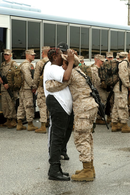 A Marine with 9th Engineer Support Battalion, says goodbye to her mother before mounting the bus May 9 on Camp Hansen. More than 140 9th ESB Marines deployed to Afghanistan.