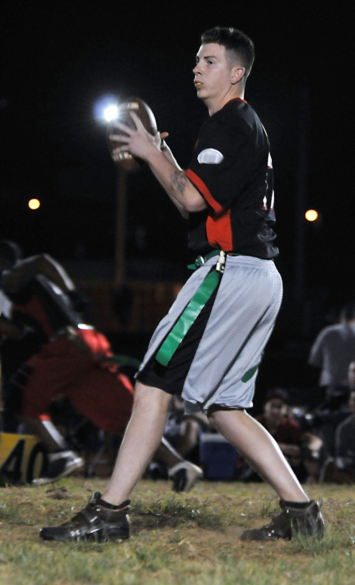 ANDERSEN AIR FORCE BASE, Guam - Aaron Korwaski, quarterback for the 736th Security Forces Squadron flag football team, drops back to throw a pass in the base championship game versus the 554th RED HORSE Squadron here March 29. The game was a defensive battle that featured multiple interceptions and was not decided untill the final minutes of the game. In the end, the 554th RHS prevailed with a 10-0 victory. (U.S. Air Force photo by Airman 1st Class Julian North)