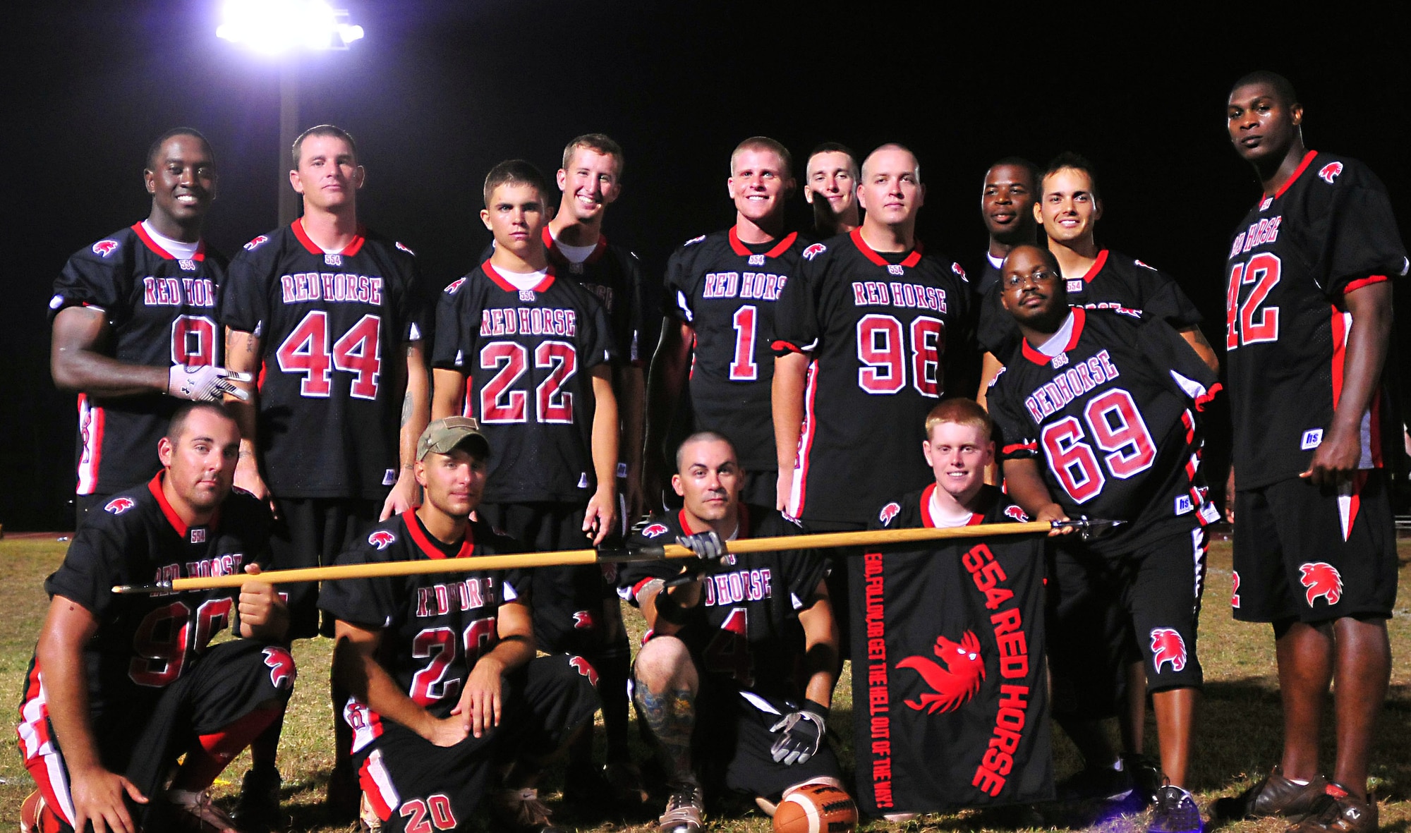 ANDERSEN AIR FORCE BASE, Guam - Members of the 554th RED HORSE Squadron flag football team pose for a group photo after defeating the 736th Security Forces Squadron team 10-0 in the base intramural flag championship here March 29. The members of the team include: Coach Robert Davis, No. 2 Scott Forrest, No. 1 Ryan Halter, No. 9 Mardie Wilson,  No. 44 Christopher Roberson,  No. 42 Taiwan Jackson,  No. 22 Jarrod Bricker, No. 98 Brandon Hall, No. 99 Jason Brashar, No. 33 Michael Bullard,  No. 4 Andrew Cuevas,  No. 20 Michael Rich,  No. 26 Cody Ott,  No. 3 Derek Borough, Marc Warner, (Not Pictured) No. 15 Andrew McConkay, No. 88 Daniel Pauls, and No. 23 Cameron Pleasant. (U.S. Air Force photo by Airman 1st Class Julian North)