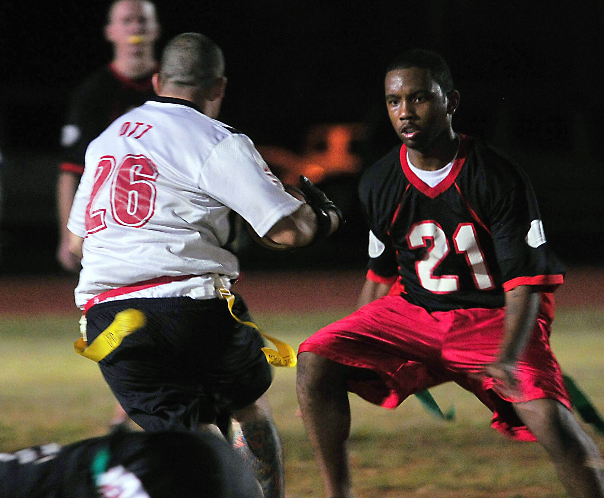 ANDERSEN AIR FORCE BASE, Guam - No. 26 Cody Ott, 554th RED HORSE Squadron, avoids a 736th Security Forces defender during the base intramural flag football championship game here March 29. Behind solid defense and a great rushing and passing output by quarterback Michael Rich, RHS came away with a 10-0 victory (U.S. Air Force photo by Airman 1st Class Julian North)