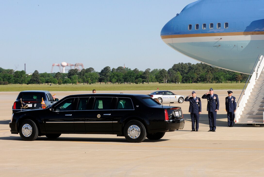 LANGLEY AIR FORCE BASE, Va. -- Lt. Gen. William Rew, Air Combat Command vice commander, and Col. Donald E. Kirkland, 633d Air Base Wing commander, salute the presidential motorcade during its' departure to Hampton University May 9. President Obama delivered the commencement address at the school, emphasizing the importance of education and good citizenship to graduates. (U.S. Air Force photo/Senior Airman Dana Hill)