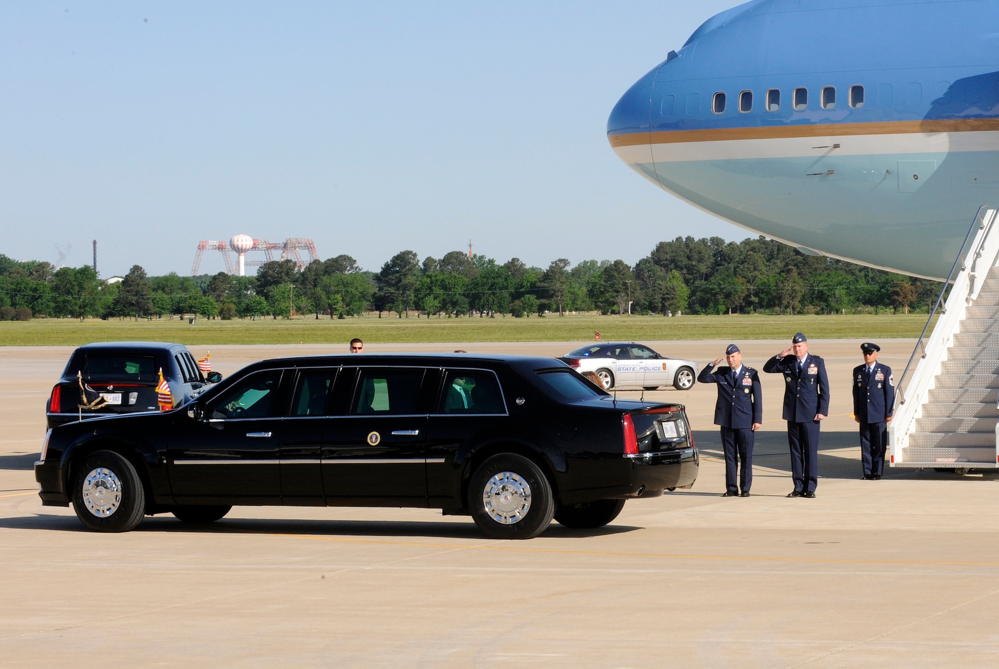 LANGLEY AIR FORCE BASE, Va. -- Lt. Gen. William Rew, Air Combat Command vice commander, and Col. Donald E. Kirkland, 633d Air Base Wing commander, salute the presidential motorcade during its' departure to Hampton University May 9. President Obama delivered the commencement address at the school, emphasizing the importance of education and good citizenship to graduates. (U.S. Air Force photo/Senior Airman Dana Hill)