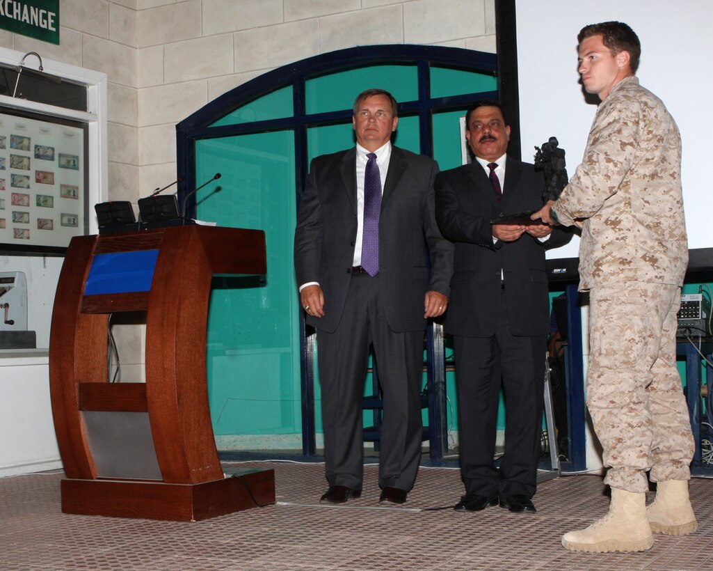 Staff Sgt. Clint Michalek, team leader from Force Reconnaissance Platoon, 24th Marine Expeditionary Unit, accepts the 1st Place trophy on behalf of his team at the 2nd Annual Warrior Competition during an award ceremony hosted by King Abdullah II Special Operations Training Center (KASOTC) in Jordan May 9, 2010.  The Force Reconnaissance team, long with a team from the battalion reconnaissance platoon from Battalion Landing Team 1st Bn, 9th Marine Regt, (both assigned to the 24th Marine Expeditionary Unit) competed in various events against Special Forces units from foreign countries, testing their communication, marksmanship and team work.  The 24th MEU is currently on a seven-month deployment with the Nassau Amphibious Ready Group, and is currently serving as the theatre reserve force for Central Command.   (U.S. Marine Corps photo by Sgt. Alex C Sauceda)::r::::n::::r::::n::