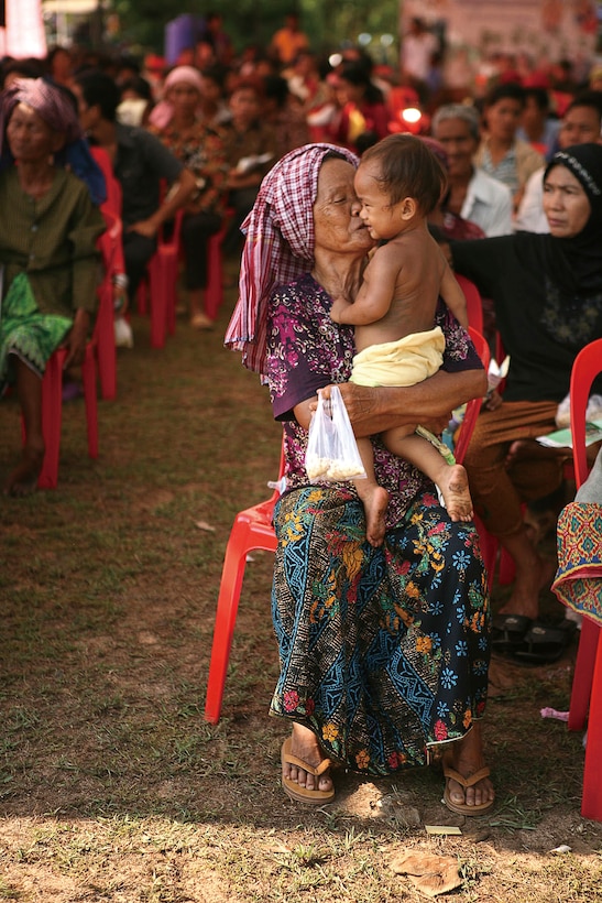 A Cambodian woman brings her grandson to see doctors May 10 at the Friendship Clinic in Kampong Chhnang Province during the fourth annual Cambodian Interoperability Program 2010. More than 1,000 people waited outside the clinic before it opened.
