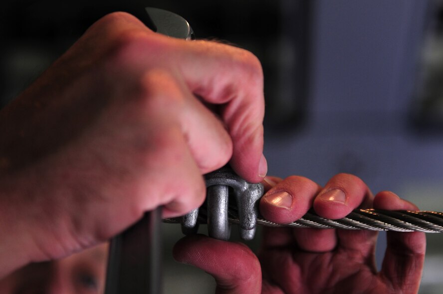 U.S. Air Force Tech. Sgt. David Dais, 37th Airlift Squadron loadmaster, affixes a static line in preparation of the Romanian Airmen that are being welcomed onto the U.S. Air Force C-130J to perform paratrooper training as part of the multi nation exercise Carpathian Summer, Airlift Base Otopeni, Romania, May 10, 2010. Carpathian Summer 2010 was an exercise in which the Romanian Air Force invited members of the U.S. military to train with them on their soil and air space, to observe, firsthand, operations in action. This exercise was designed to build partnerships between these nations in an effort to work together more efficiently during real world scenarios. (U.S. Air Force Photo by Staff Sgt. Jocelyn Rich)