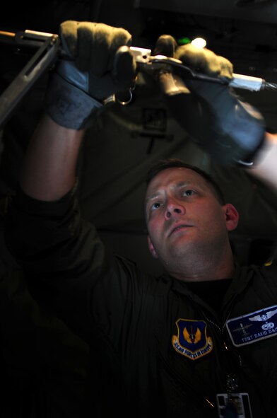U.S. Air Force Tech. Sgt. David Dais, 37th Airlift Squadron loadmaster, affixes a static line in preparation for Romanian Airmen that are being welcomed onto a C-130J Hercules to perform paratrooper training as part of the joint nation exercise Carpathian Summer, Airlift Base Otopeni, Romania, May 10, 2010. Members of the U.S. and Romanian Air Forces joined together for a week long exercise to build partnerships and enhance proficiency in working together. (U.S. Air Force Photo by Staff Sgt. Jocelyn Rich)