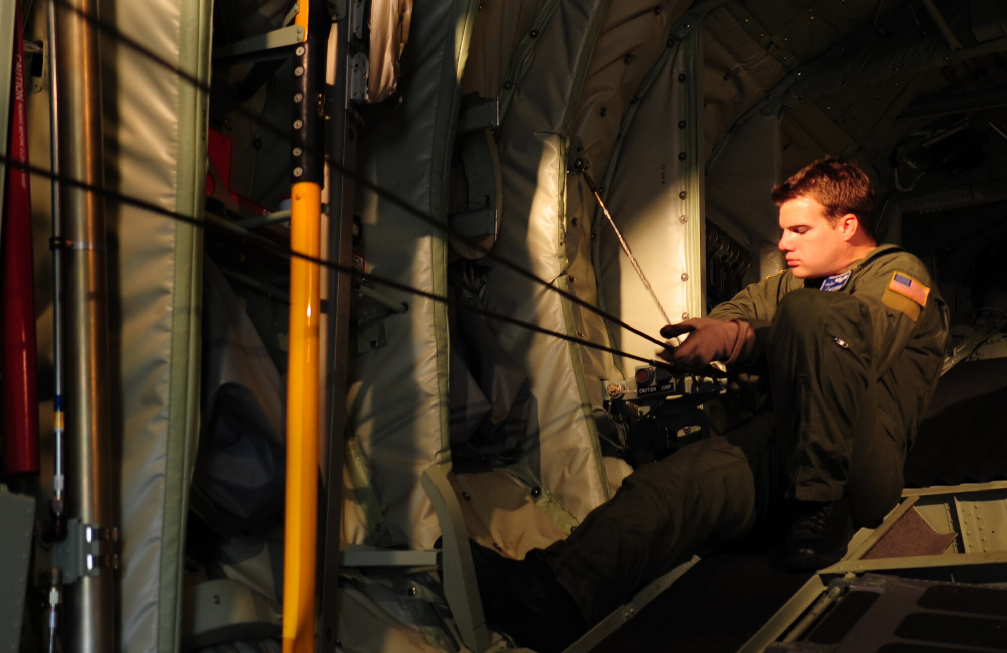 U.S. Air Force Staff Sgt. Brett Hunter, 37th Airlift Squadron loadmaster, affixes a static line in preparation for Romanian Airmen being welcomed onto a C-130J to perform paratrooper training as part of the joint nation exercise Carpathian Summer, Airlift Base Otopeni, Romania, May 10, 2010. Members of the U.S. and Romanian Air Forces joined together for a week long exercise to build partnerships and enhance proficiency in working together. (U.S. Air Force Photo by Staff Sgt. Jocelyn Rich)