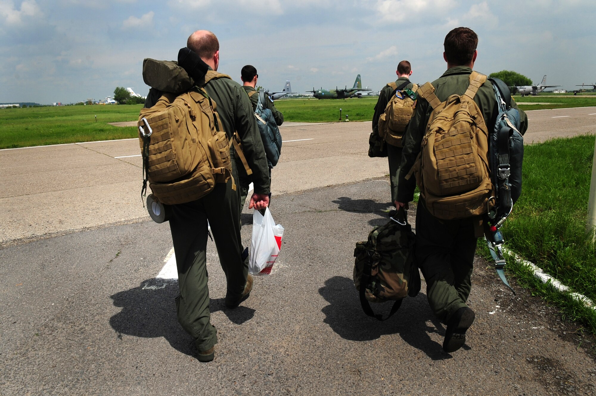 Members of the 37th Airlift Squadron make their way to their U.S. Air Force C-130J from Ramstein Air Base Germany, here at Otopesti Airlift Base, Romania, May 10, 2010. Members of the U.S. and Romanian Air Forces joined together for a week long exercise to build partnerships and enhance proficiency in working together. (U.S. Air Force Photo by Staff Sgt. Jocelyn Rich)
