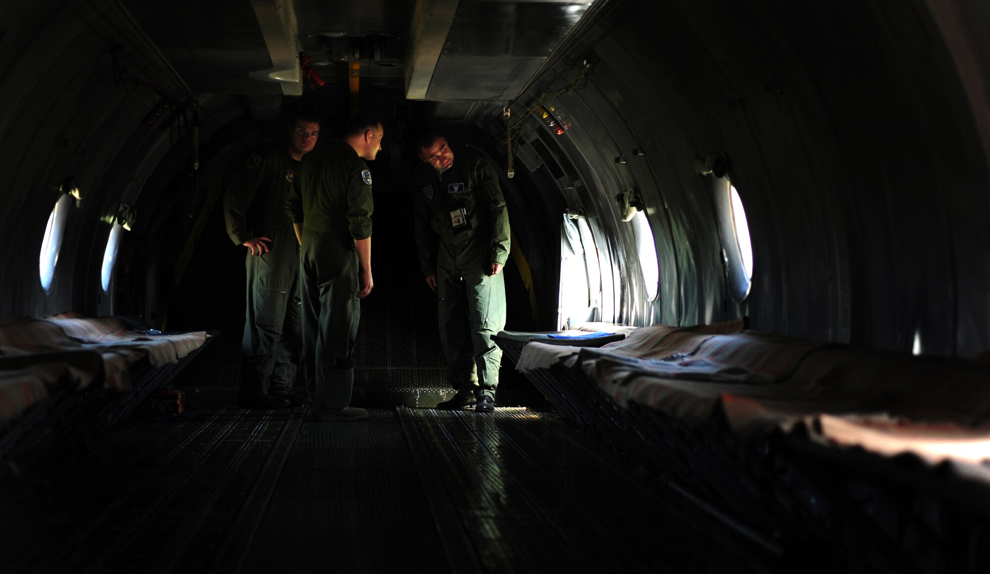 U.S. Air Force Staff Sgt. Brett Hunter, and Tech.Sgt. David Dais, 37th Airlift Squadron loadmasters, tour a Romanian C-130B with the flight engineer Nicu Romica, Otopeni Airlift Base, Romania, May 10, 2010. Members of the U.S. and Romanian Air Forces joined together for a week long exercise to build partnerships and enhance proficiency in working together. (U.S. Air Force Photo by Staff Sgt. Jocelyn Rich)