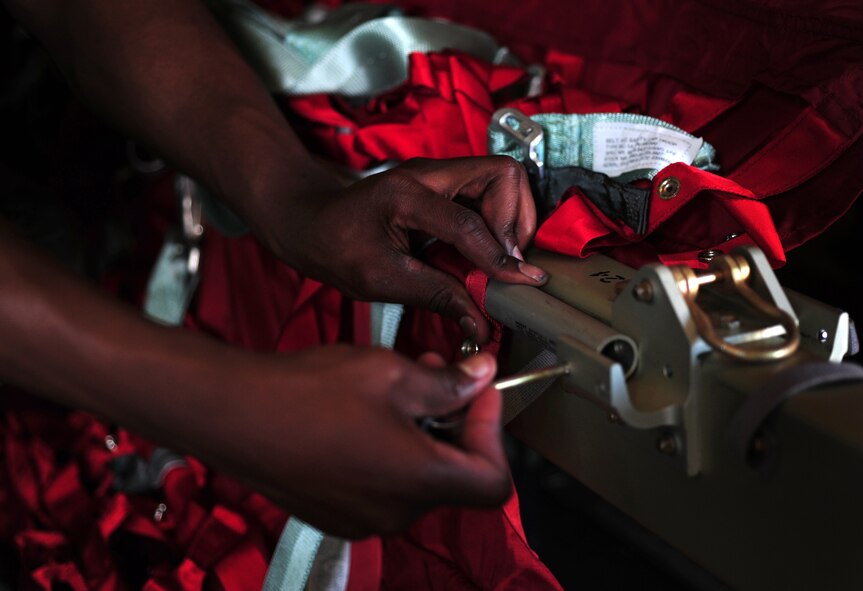 U.S. Air Force Senior Airman Travis Dale, 86 Aircraft Maintenance Squadron crew chief, assembles additional jump seats in a C-130J in preparation for Romanian Air Force paratroopers during the joint exercise Carpathian Summer, Otopeni Airlift Base, Romania, May 10, 2010. Members of the U.S. and Romanian Air Forces joined together for a week long exercise to build partnerships and enhance proficiency in working together. (U.S. Air Force Photo by Staff Sgt. Jocelyn Rich)