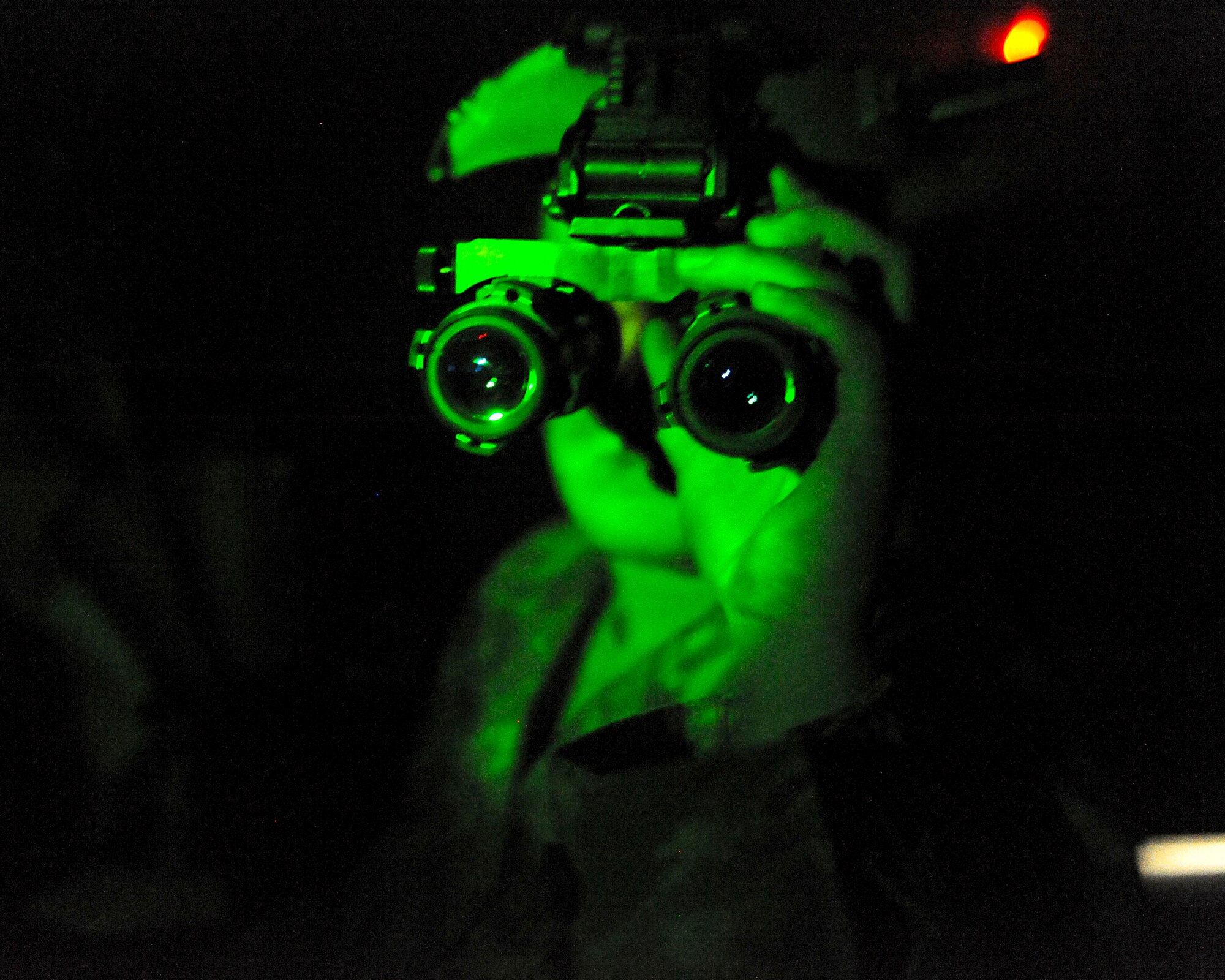 ELMENDORF AIR FORCE BASE, Alaska—Airman 1st Class Jill Brumley, 19th Fighter Squadron Aircrew Flight Equipment specialist, looks through Night Vision Goggles while inspecting them May 6. Airman Brumley, along with the other 19th FS members, will be reassigned to a new squadron after the 19th FS is deactivated in September. (Air Force photo by Airman 1st Class Jack Sanders)