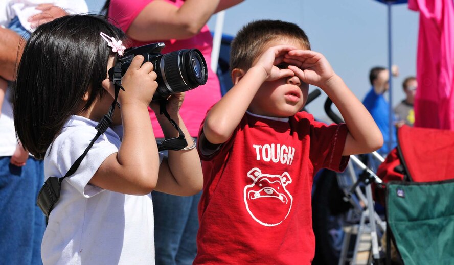 Children enjoy the performances at the March Field AirFest, March Air Reserve Base, Calif., May 2, 2010. The AirFest is a bi-annual, two-day event featuring military and civilian aerial performances and static displays of modern and historic aircraft. (U.S. Air Force photo by Senior Airman Juan Duenas/Released)