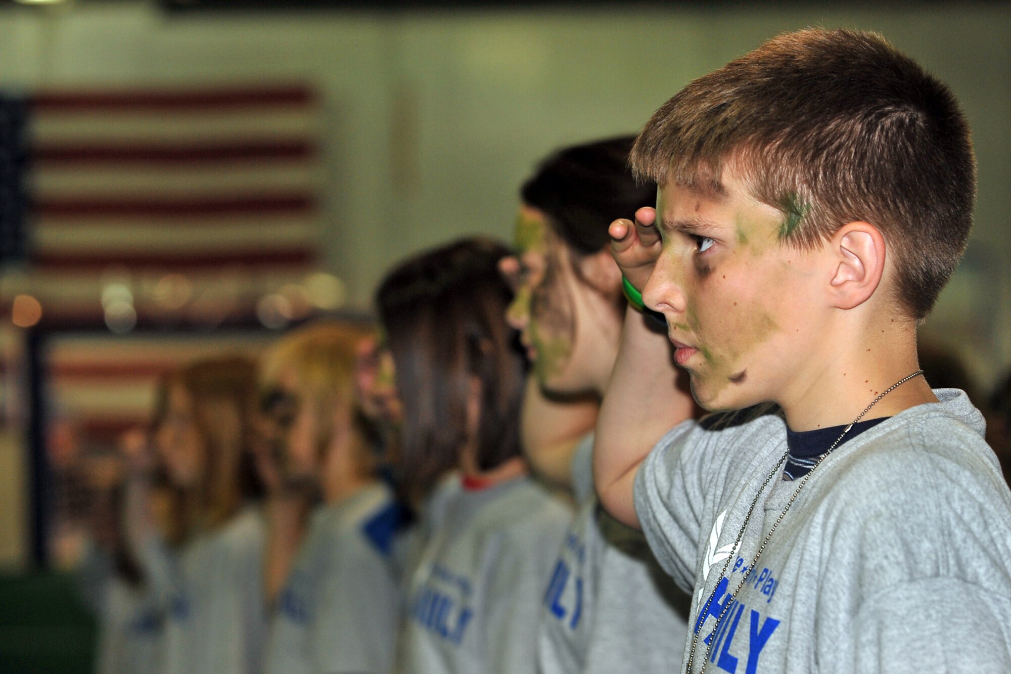 OFFUTT AIR FORCE BASE, Neb. -- Hunter Rausch, the son of Col. Douglas Rausch, U.S. Strategic Command, renders a salute during the Junior PDF Line May 7 at the Offutt Field House. More than 260 military children attended the event to gain a better understanding of what their parents experience when they deploy. U.S. Air Force Photo by Charles Haymond