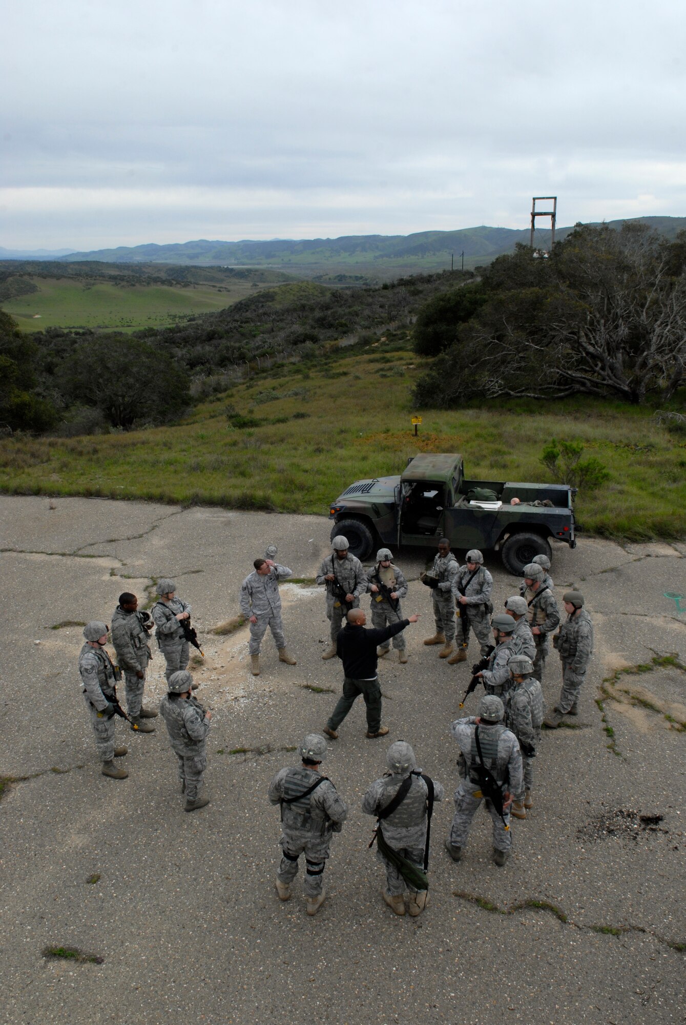 VANDENBERG AIR FORCE BASE, Calif. -- Chris Baltazar and Staff Sgt. Jesse McKee, the 30th Security Forces Squadron training instructors, review combat tactics with Airmen during a convoy training exercise here Tuesday, Feb. 23, 2010.  The instructors reviewed the scenario to reinforce proper procedures and teamwork.  (U.S. Air Force photo/Senior Airman Andrew Satran) 

 


 


 
