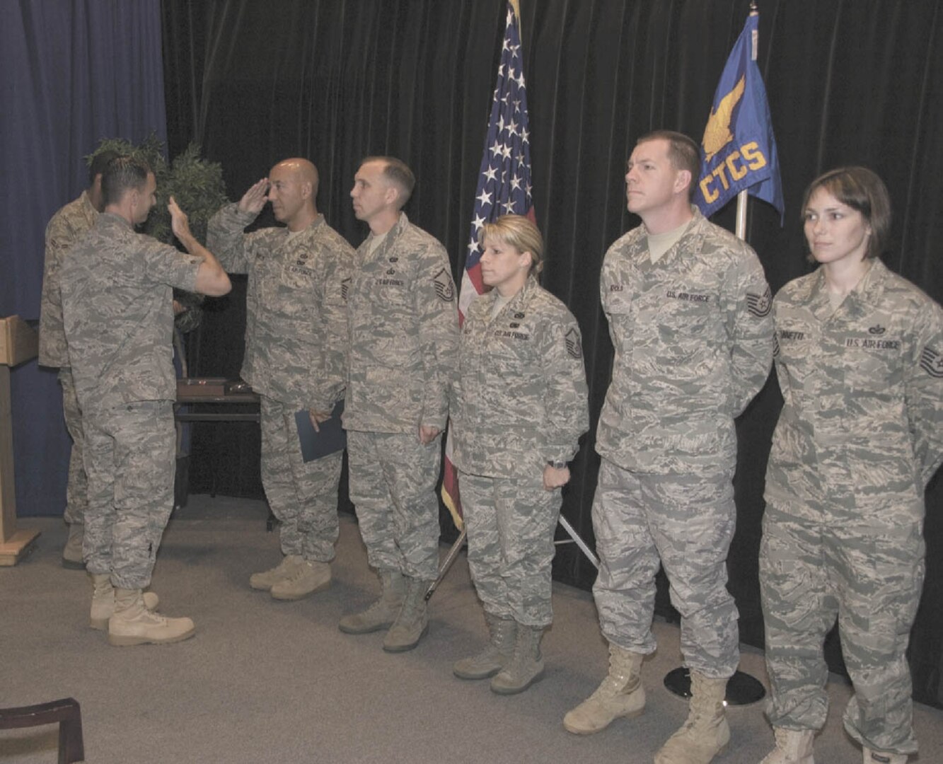 Maj. Thomas Knowles, (left) 3rd Combat Camera Squadron commander, presents training certificates and combat camera patches at the squadron’s inaugural combat correspondent (video) training course graduation ceremony at Lackland April 30. The course’s first graduates (left to right) are Master Sgt. Robert Shields, Master Sgt. Michael Hamill, Master Sgt. Piper Faulisi, Tech. Sgt. Kevin Nichols and Tech. Sgt. Rebecca Zannetti. (U.S. Air Force photo by Steve Ninotta)
