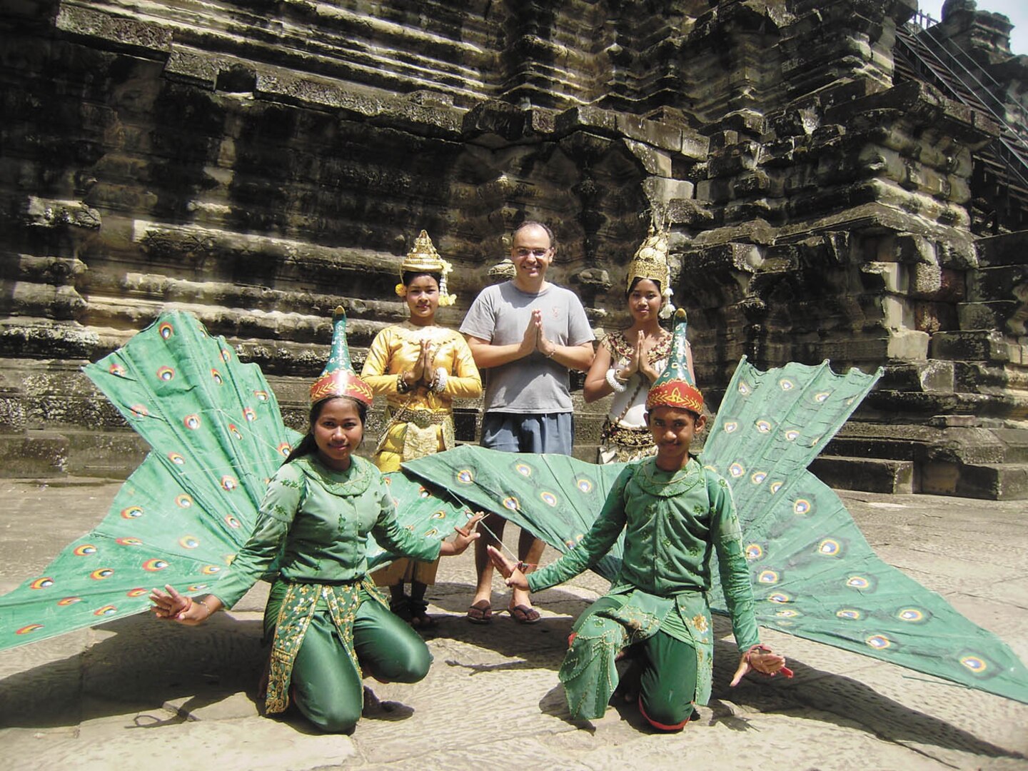 Michael Sheridan, Defense Language Institute English Language Center senior instructor, stands with locals outside the ruins of Angkor Wat, a 12th century stone temple in Angkor, Cambodia. In 2009, Mr. Sheridan spent six months providing language and technical assistance to Cambodian instructors in the first extended in-country training for the DLIELC nonresident program in the country. (Courtesy photo)