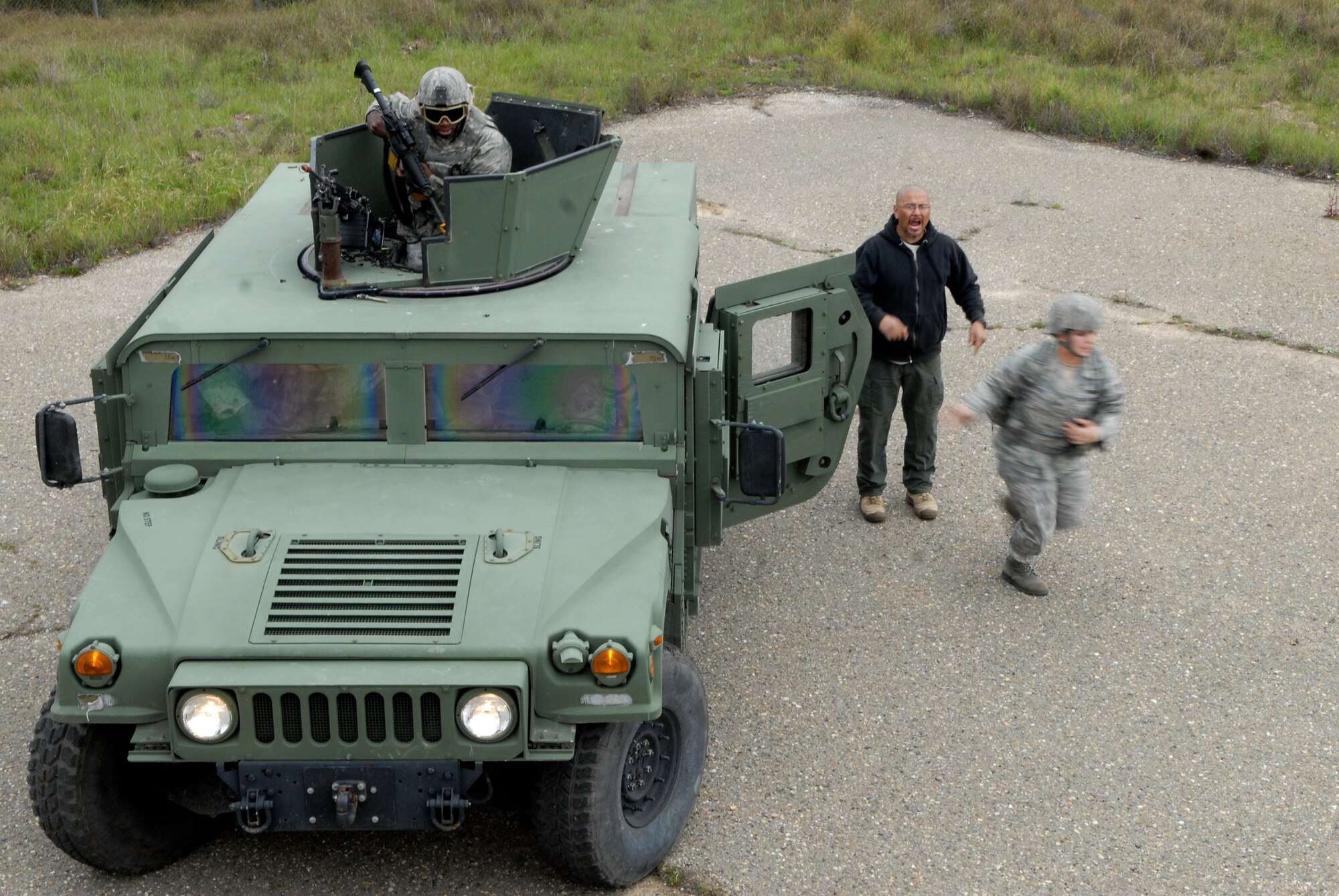 VANDENBERG AIR FORCE BASE, Calif. -- Chris Baltazar, a 30th Security Forces Squadron training instructor, motivates Senior Airman Britnee Mitchell, a 30th SFS member, during a convoy exercise here Tuesday, Feb. 23, 2010.  The course provides the Airmen with a general knowledge and understanding of combat tactics that will aid them in their duties.  (U.S. Air Force photo/Senior Airman Andrew Satran) 

 

 

 



 