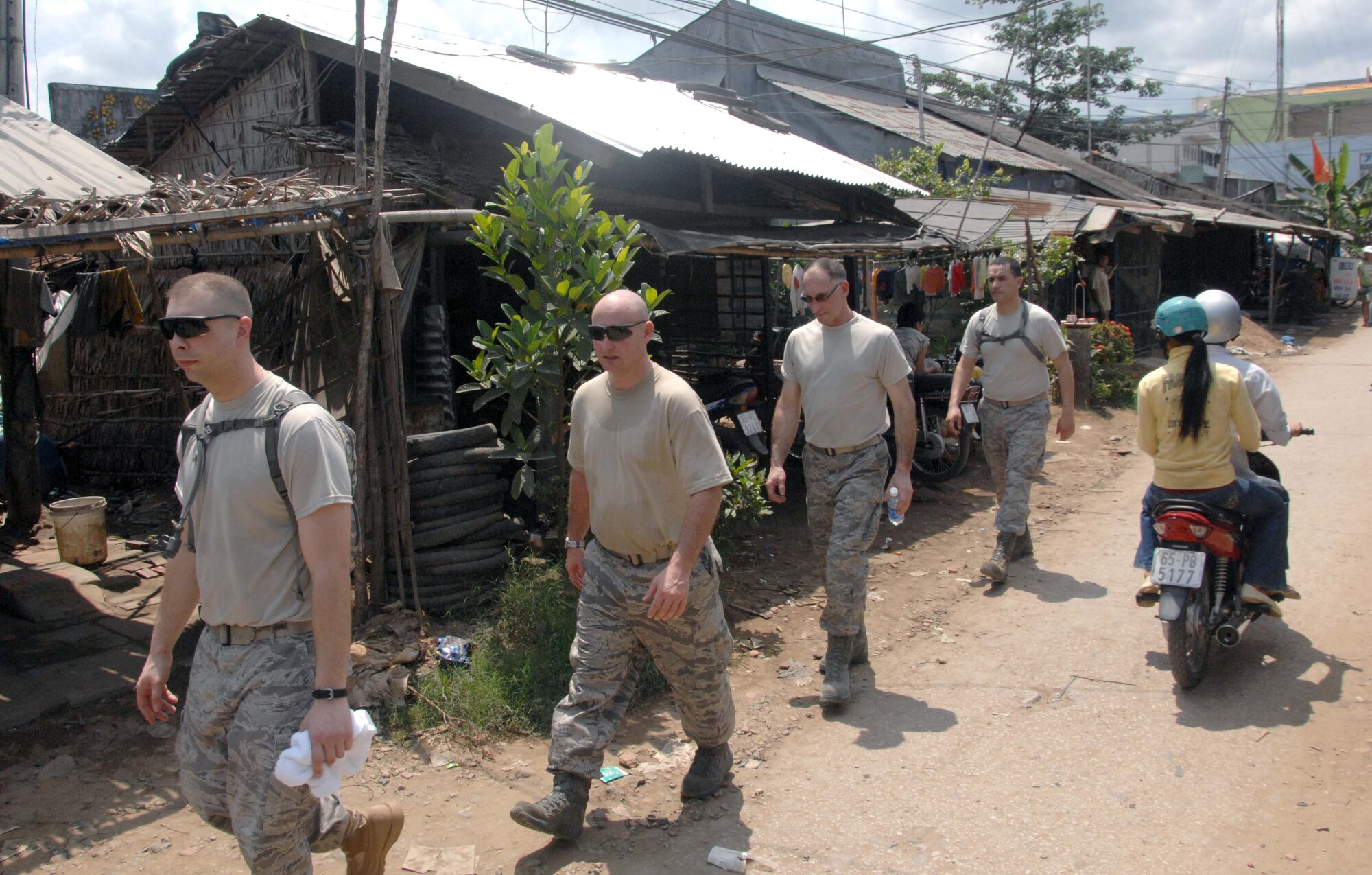 (From left to right) Tech.Sgt. Rick Wolfe, Master Sgt. Jeff Ruckman, Master Sgt. John Swearingin and Staff Sgt. Airman Michael Zamora walk from the village medical clinic at Tan Thoi Elementary School in Vietnam to get the tools they'll need to start engineering assistance in support of Operation Pacific Angel 10-2.  The engineers will help provide civic assistance in cooperation with members of the Vietnam military May 10-17.  (U.S. Air Force photo/Capt. Timothy Lundberg)
