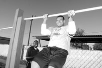 Chris Perry, Security Hill Personnel Center, participates in the pull-up contest at the Gillum Fitness Center, Tuesday. (U.S. Air Force photo by Alan Boedeker)