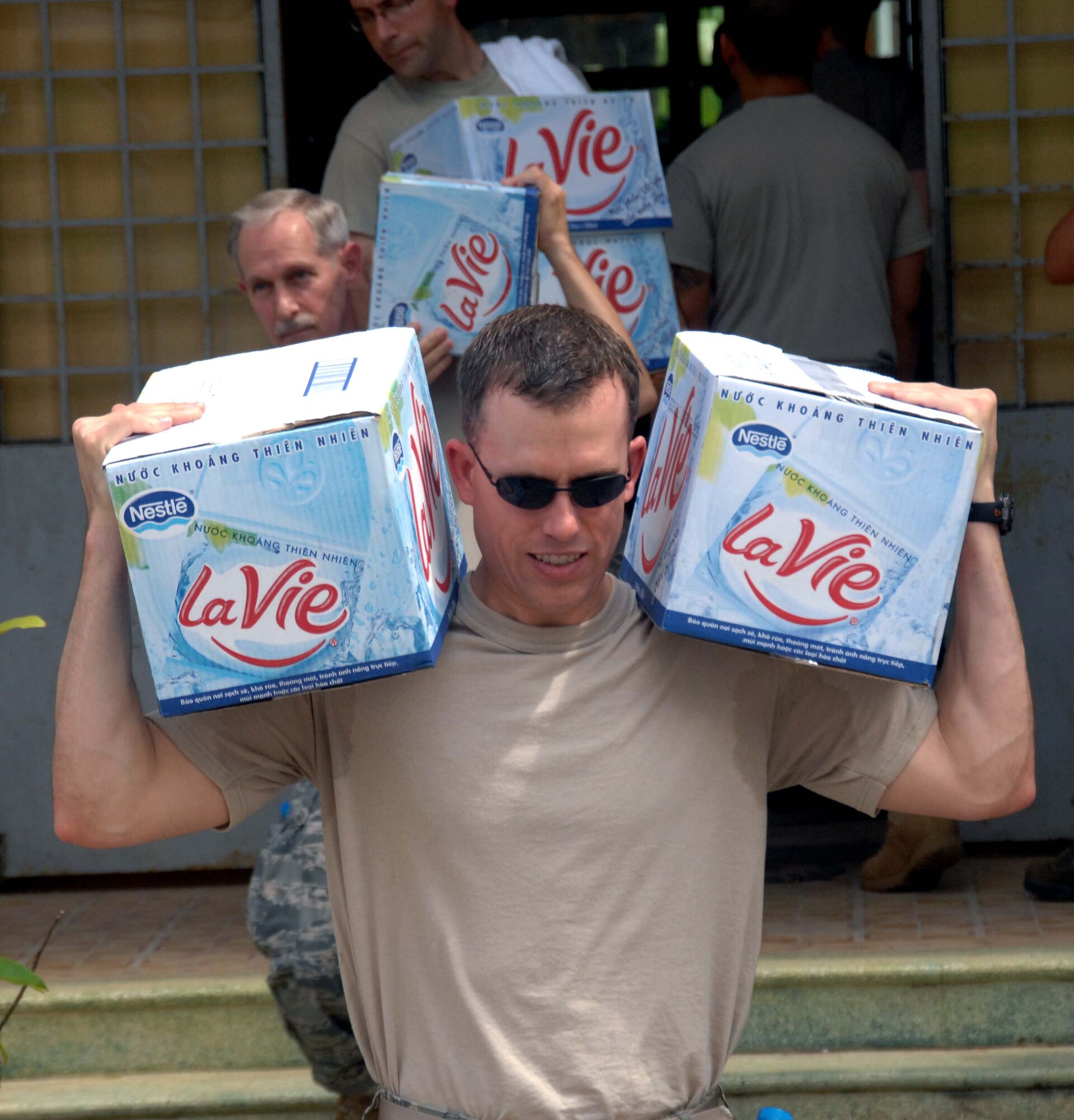 Maj. Michael Townsend brings water to the Tan Thoi Elementary School in Vietnam where a medical clinic will be established by U.S. and Vietnamese military and non-governmental officials as part of Pacific Angel 10-2, May 10-17. The clinic will provide free services in family practice, dental, optometry, pediatrics and women's health to Can Tho area residents. Major Townsend is deployed from the 374th Dental Squadron at Yokota Air Base, Japan. (U.S. Air Force photo/Capt. Timothy Lundberg)
