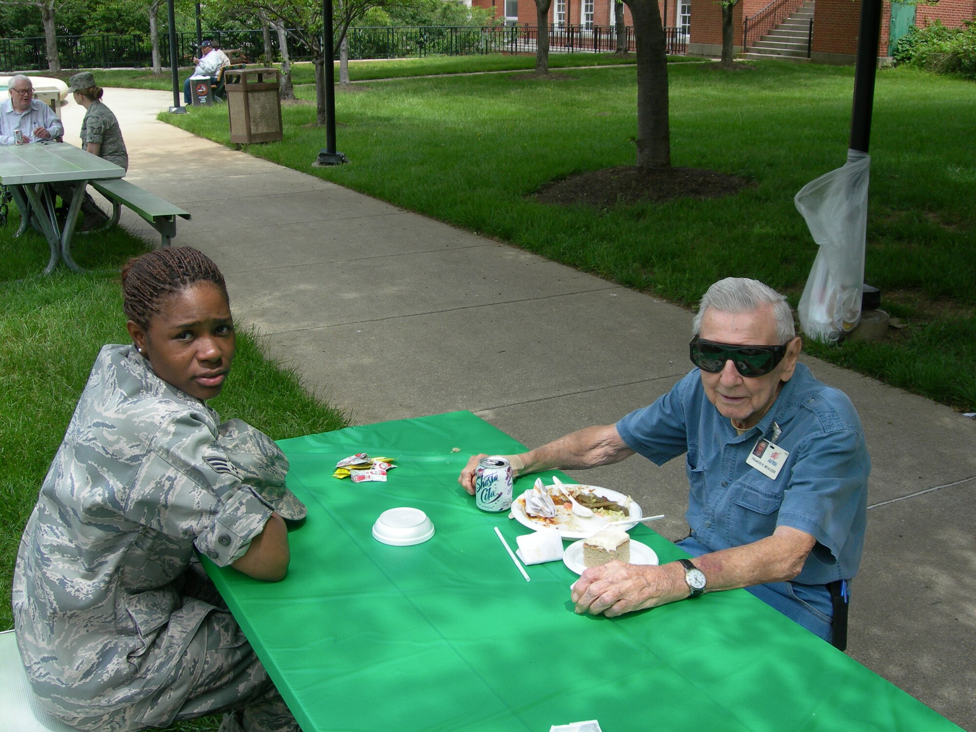 Air Force District of Washington’s Senior Airman Tiffany Miles listens as Mr. Francis McAleer, resident of Armed Forces Retirement Home shares his military memories during the May Spring Cookout for residents at the Armed Forces Retirement Home Washington, D.C., held on May 7, 2010. (U.S. photo by Aletha Frost)
