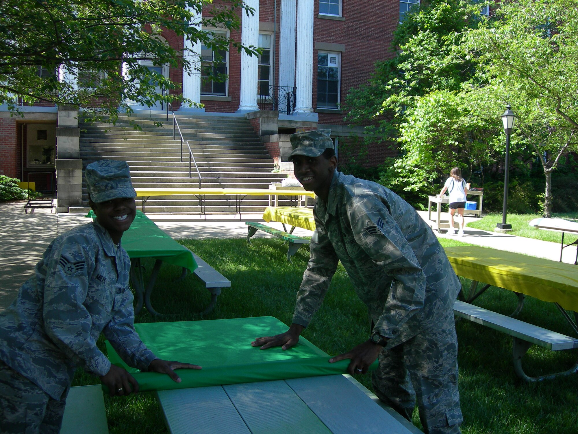 Air Force District of Washington’s Senior Airman Tiffany Miles and Carlton Dixon, Knowledge Operators prepare picnic tables for the May Spring Cookout for residents at the Armed Forces Retire Home Washington, D.C., held on May 7, 2010. (U.S. photo by Aletha Frost)