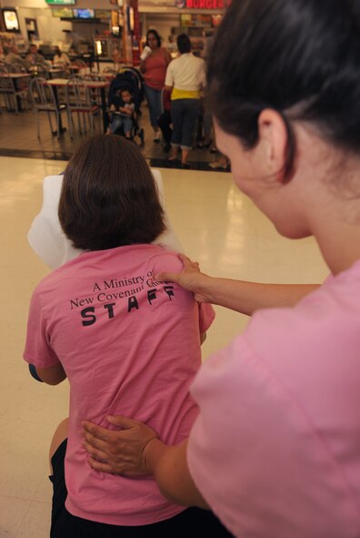 MOODY AIR FORCE BASE, Ga. -- Amanda Hadsock, local massage therapist, gives a chair massage to Alisha Warren, military spouse, during Spouses Appreciation Day here May 7. The spouses who came each received a free 10-minute massage. (U.S. Air Force photo by Airman 1st Class Benjamin Wiseman/RELEASED)