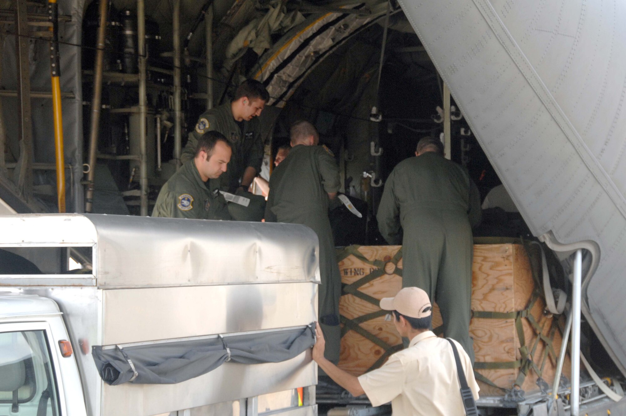 Cargo is off-loaded from a C-130 Hercules from the 144th Airlift Squadron at Kulis Air National Guard Base, Alaska shortly after they arrived at Ho Chi Minh City, Vietnam, May 8. Thirty-nine military personnel from bases around the Pacific and continental U.S. are participating in Operation Pacific Angel 10-2 in the Can Tho area May 10-17.  Pacific Angel is a humanitarian and civic assistance program conducted in the Pacific area of responsibility to support U.S. Pacific Command's capacity-building efforts. This is the second time the operation has been held in Vietnam. (U.S. Air Force photo/Capt. Timothy Lundberg)
