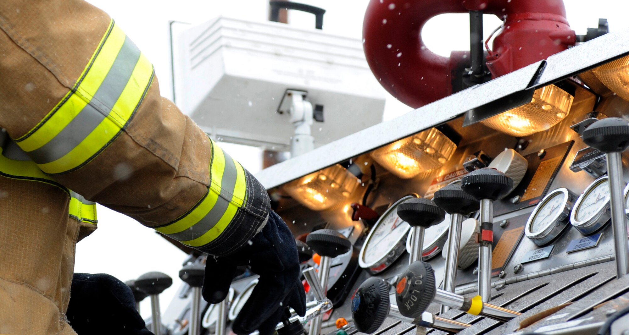 A firefighter adjusts levers at a control panel aboard a fire truck May 5, 2010, Eielson Air Force Base, Alaska. Emergency service Airmen responded to a mock aircraft crash at the fuel storage field during the May operational readiness exercise. The firefighter is a part of the 354th Civil Engineer Squadron, Fire Protection Flight. (U.S. Air Force photo/Airman 1st Class Willard E. Grande II)