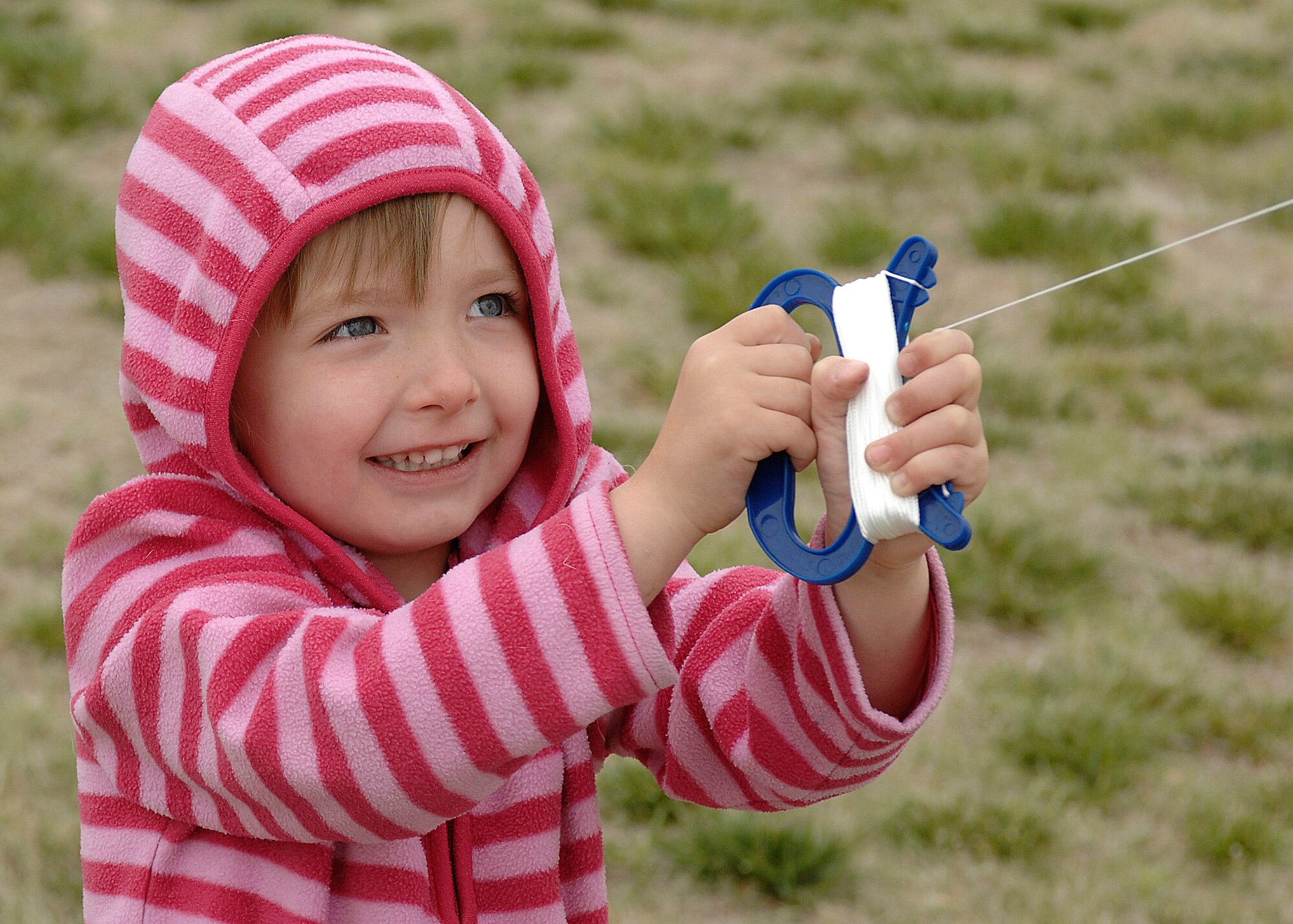 Skylar Welch, the daughter of Eir Welch, enjoys flying her kite during the seventh annual Kite Karnival May 8 at Doc Stewart Park near Cannon Air Force Base, N.M. In addition to kites, there were free train rides, music, food and other activities at the seventh annual event. (Air Force photo by Greg Allen)