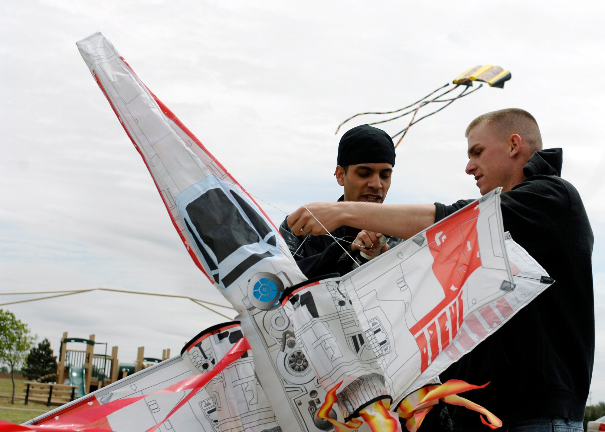 Louie Mendoza (left) and Airman 1st Class Joseph Hardeman, 27th Special Operations Civil Engineer Squadron, get ready to launch their kite during the Kite Karnival May 8 at Doc Stewart Park. Approximately 400 individuals showed up for the seventh-annual event sponsored by the 27th Special Operations Force Support Squadron. (Air Force photo by Greg Allen)