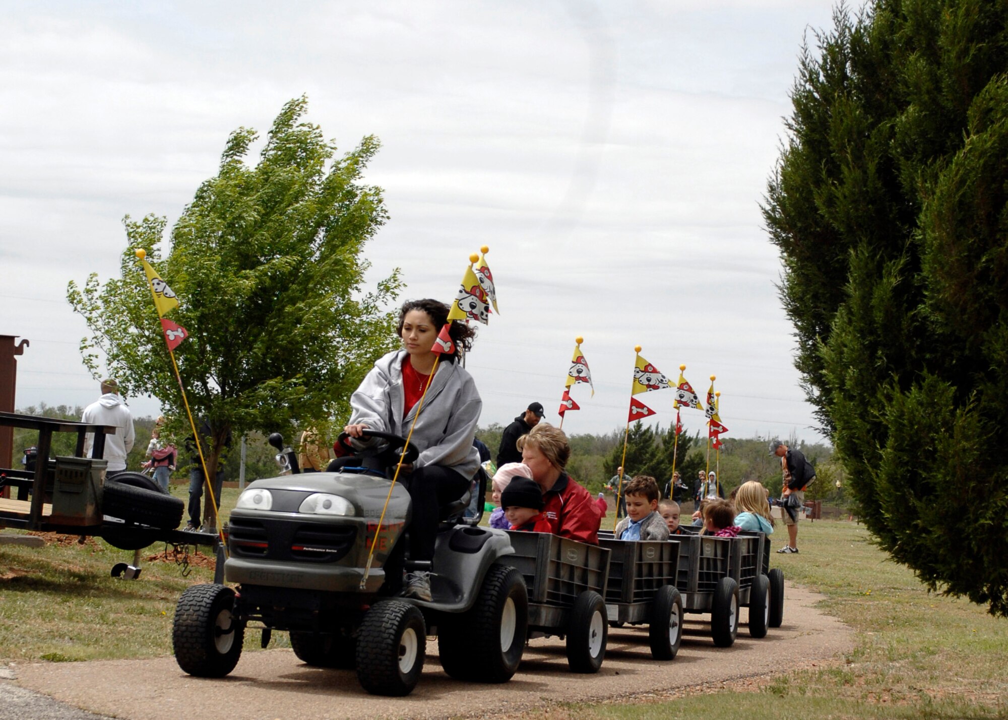 Vanessa Moore takes children on a tractor ride around Doc Stewart Park at Cannon Air Force Base, N.M., during the seventh-annual Kite Karnival May 8. In addition to kites and rides, there were bouncy castles, food toss games and more at the event. (Air Force photo by Greg Allen) 