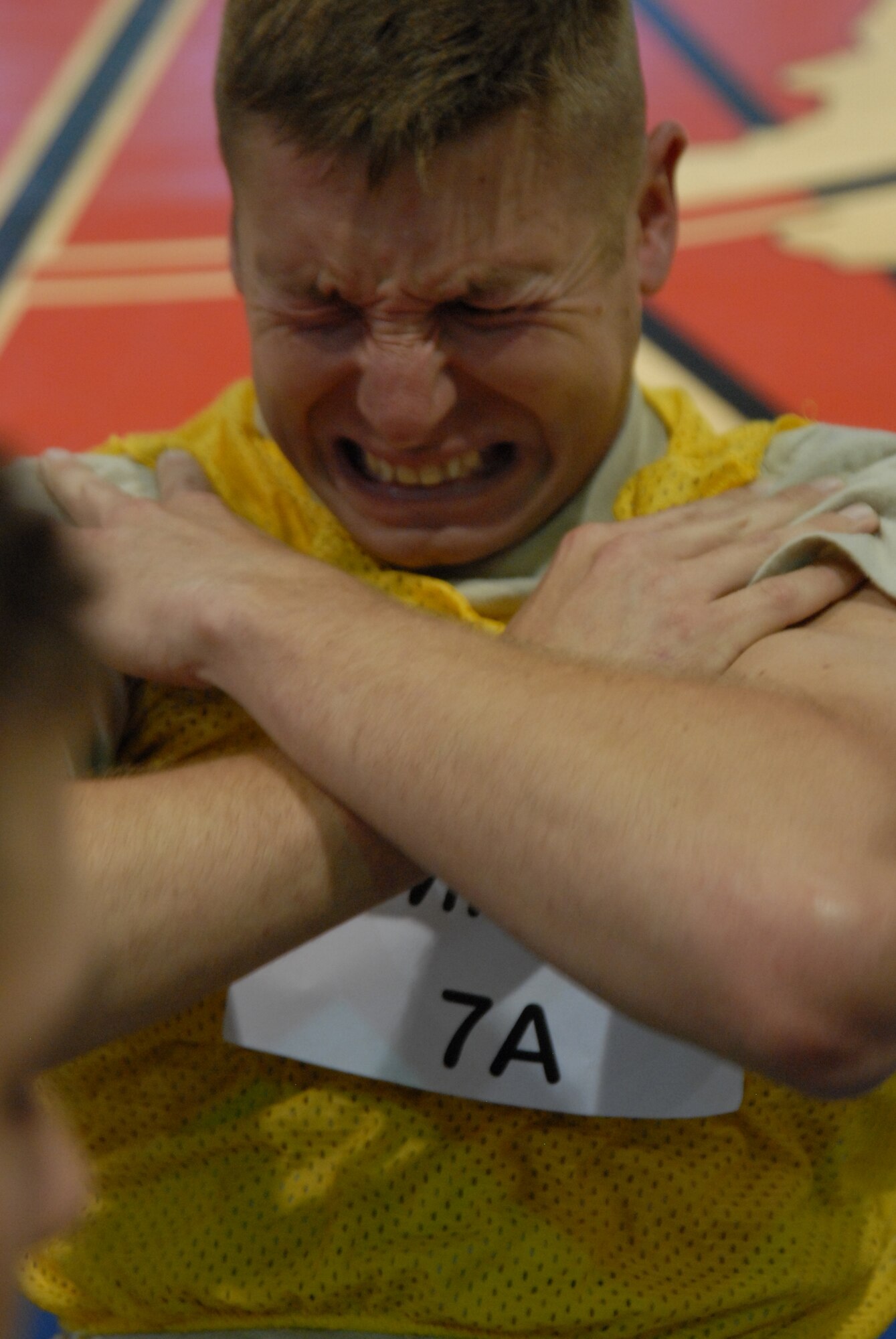 Staff Sgt. William Defoor, a Tactical Air Control Party candidate, pushes through his 94th sit-up. During the competition, Air Commandos beat Rocky McIntosh, a linebacker with the Washington Redskins, in two minutes of push-ups, sit-ups and pull-ups. Senior Airman Terry Cooper, 1st Special Operations Force Support Squadron, topped the charts by obtaining a cumulative score of 263 versus the linebacker's 189. (DoD photo by U. S. Air Force Staff Sgt. Orly N. Tyrell/Released)
