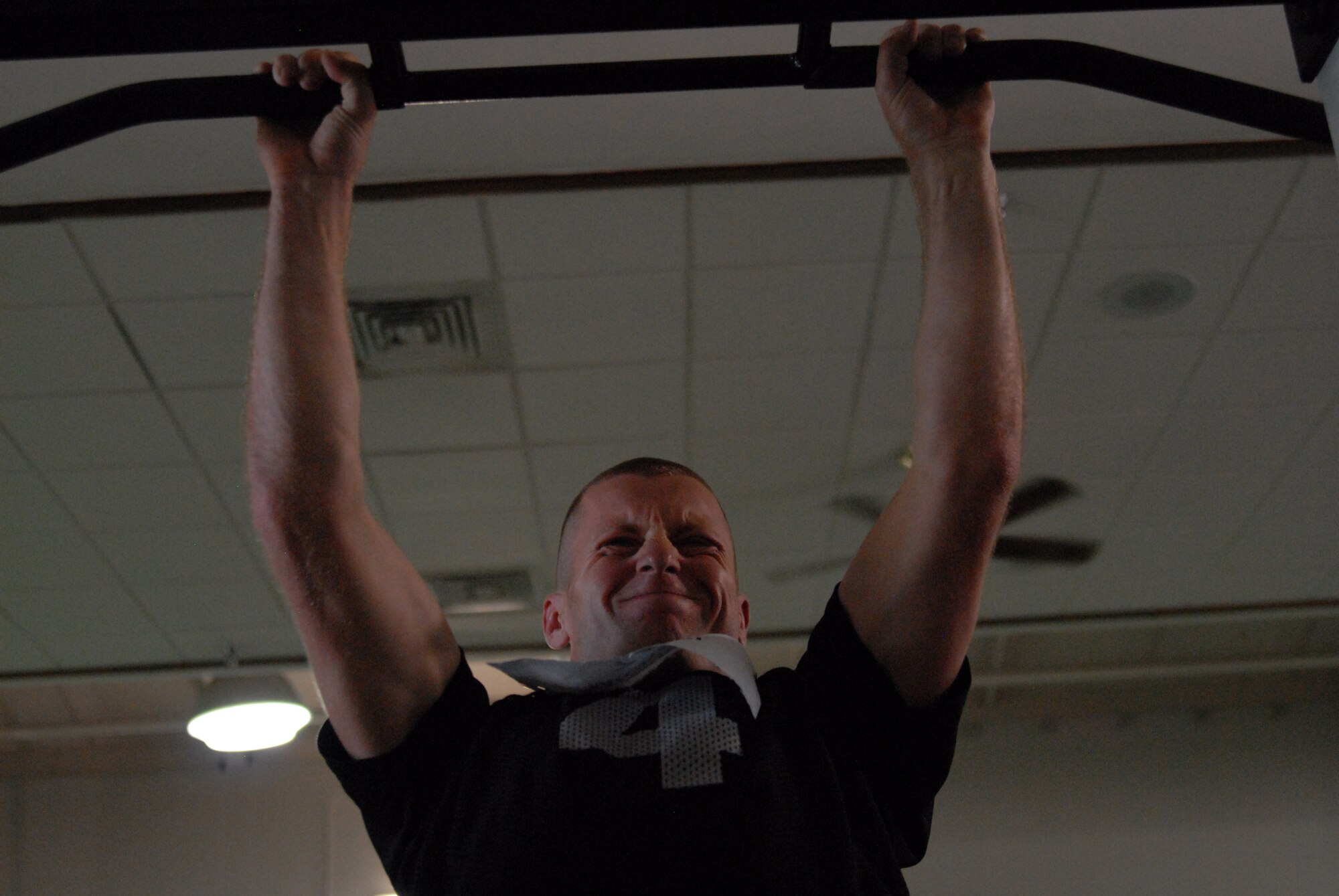 Airman 1st Class Michael Camp, a Tactical Air Control Party candidate, does pull-ups during the Air Commandos vs. Rocky McIntosh Competition at Hurlburt Field, Fla., May 4, 2010.  During the competition, the Air Commandos beat McIntosh, a linebacker with the Washington Redskins, in two minutes of push-ups, sit-ups and pull-ups. Senior Airman Terry Cooper from the 1st Special Operations Force Support Squadron topped the charts with a cumulative score of 263 versus the linebacker's 189. (DoD photo by U. S. Air Force Staff Sgt. Orly N. Tyrell/Released)