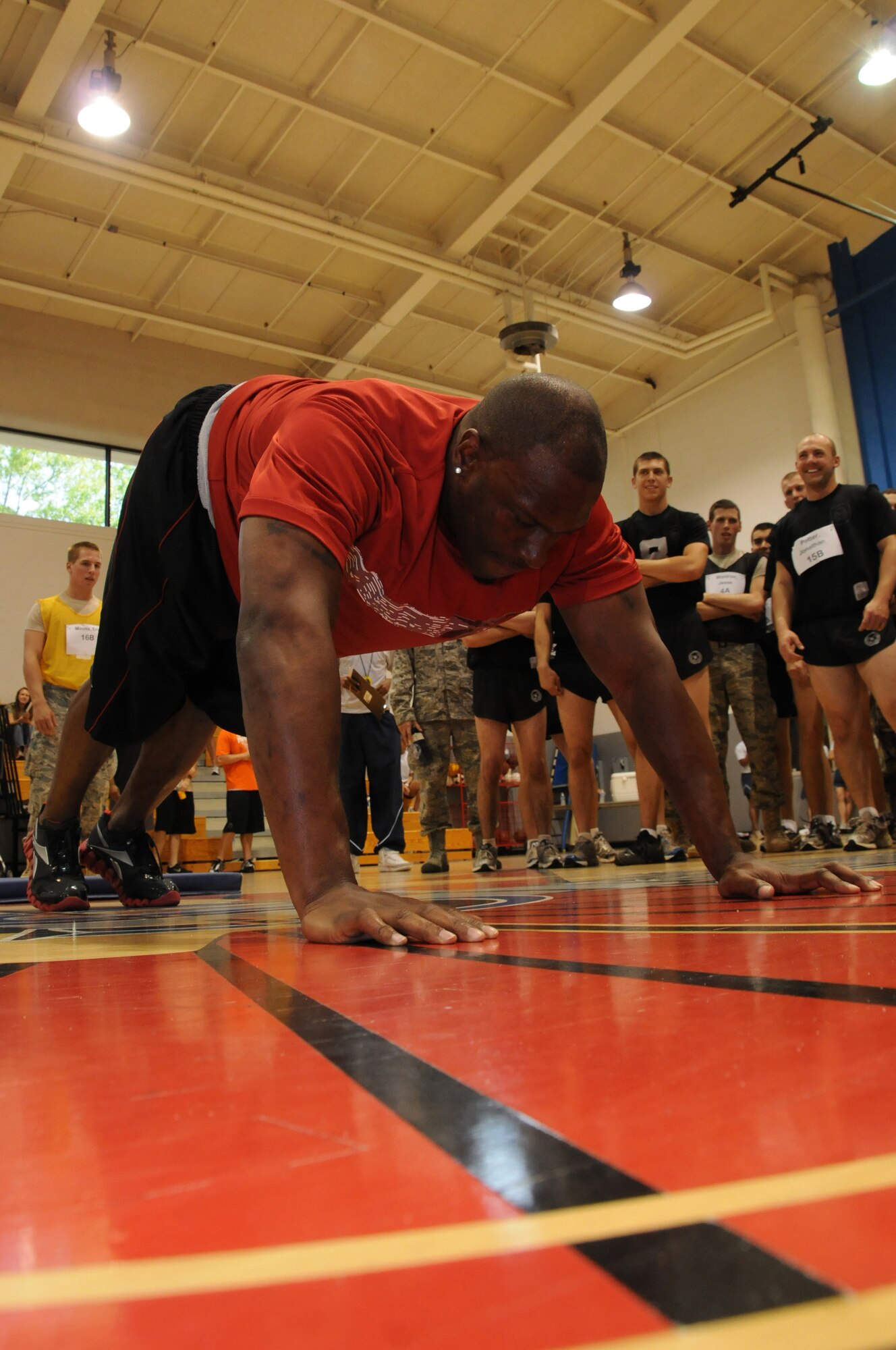 National Football League linebacker Rocky McIntosh, #52 Washington Redskins, takes a break in between push-ups during the Air Commandos vs. Rocky McIntosh Competition at Hurlburt Field, Fla., May 4, 2010.  During the competition, Air Commandos and civilians beat McIntosh in two minutes of push-ups, sit-ups and pull-ups, with Senior Airman Terry Cooper from the 1st Special Operations Force Support Squadron topping the charts by obtaining a cumulative score of 263 versus the linebacker's 189.  (U. S. Air Force photo by Reuben Garcia/Released)